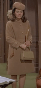 Who knew a completely camel outfit could look so chic? Here, Welles' beret, coat and purse rise above the Winter style hump.