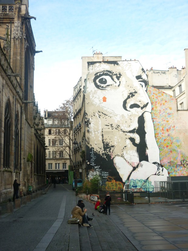 A massive graffiti image of Salvador Dalí adjacent to the Centre Pompidou.