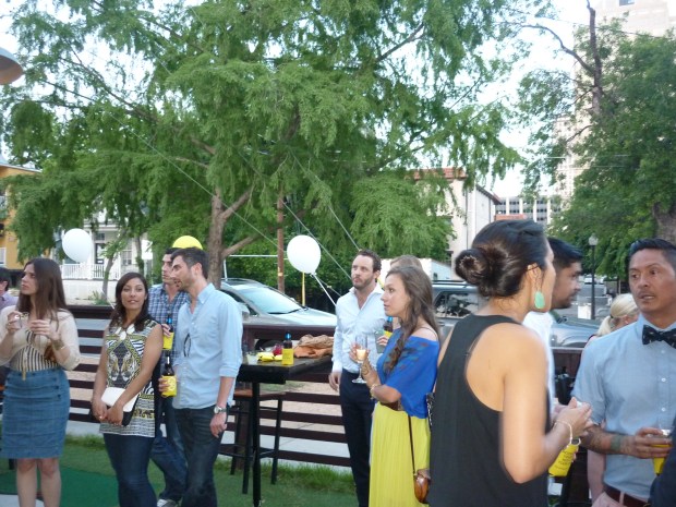 Guests standing, conversing and watching the show.